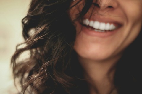 close up picture of a woman smiling showing beautiful white teeth